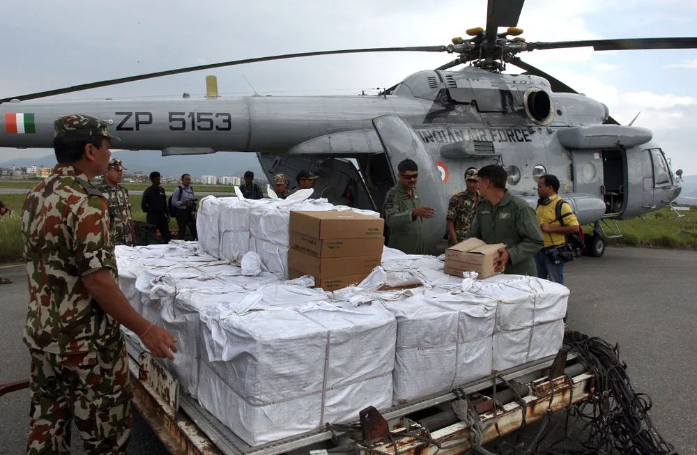 Nepalese Army personnel load relief material onto an Indian Air Force Mi-17 helicopter at Kathmandu, 27 April 2015.