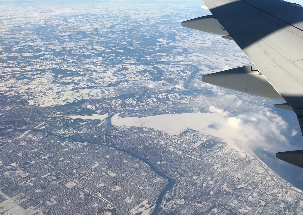 Aerial view of Hamilton, Ontario, looking northwest, 26 January 2022, with frozen Hamilton Harbour and open Lake Ontario beyond.