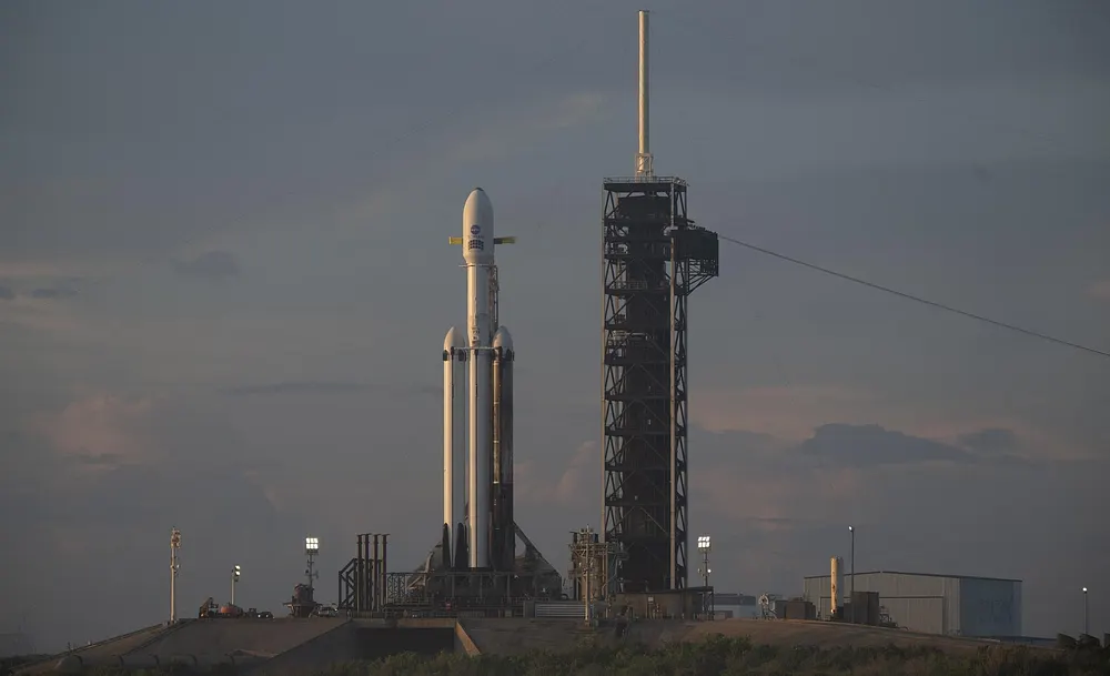 NASA's Nancy Grace Roman Space Telescope, encapsulated in its payload fairing atop a SpaceX Falcon Heavy rocket, at sunrise at Launch Complex 39A, Kennedy Space Center, Florida, 29 August 2026.