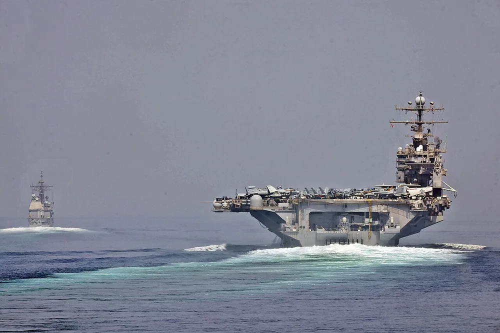 USS Cape St. George (CG 71) and USS Abraham Lincoln (CVN 72) transit the Strait of Hormuz on 11 May 2012.
