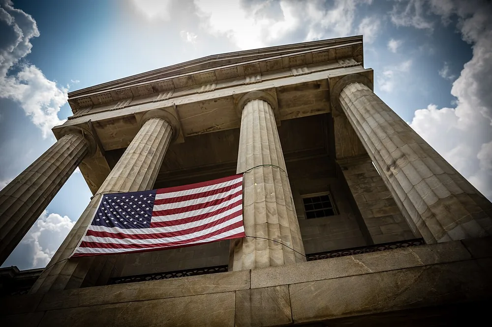 The North Carolina State Capitol in Raleigh with the United States flag.