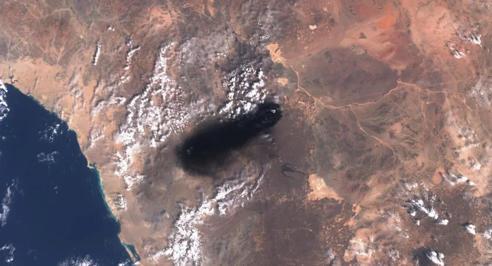 Smoke rises along Saudi Arabia's East-West crude oil pipeline in a Copernicus Sentinel satellite view.