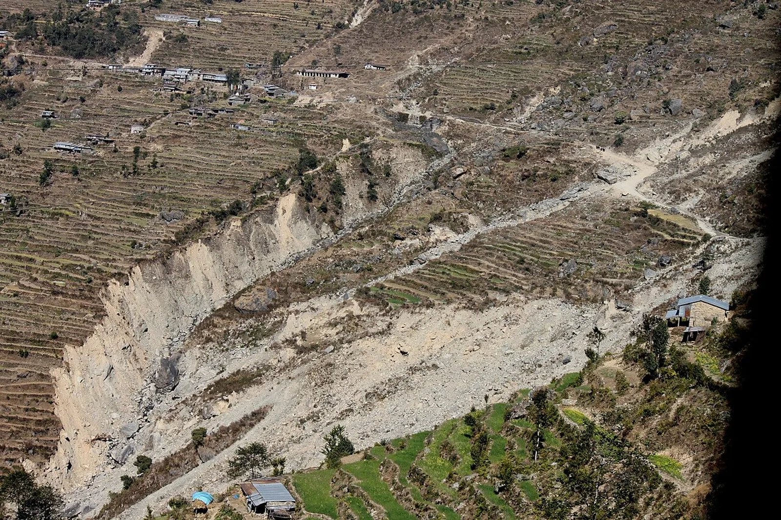 Landslide scar across terraced hillsides in Nepal's Rasuwa district. New landslides compounded flooding that has left mo