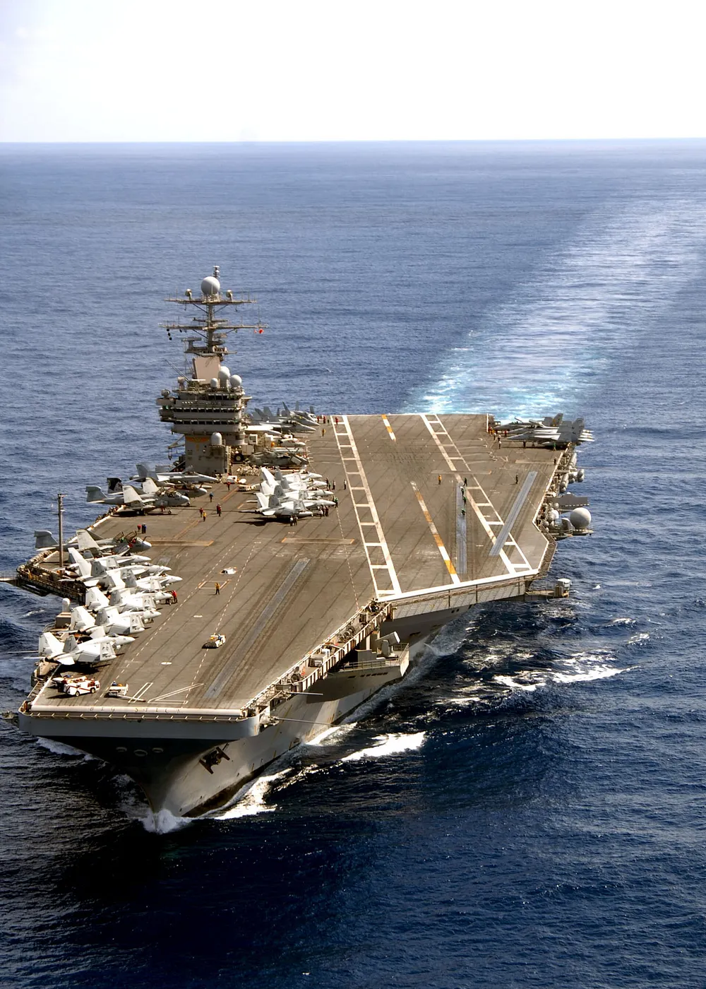 Aerial view of USS Theodore Roosevelt (CVN-71) underway with a long wake. Photo: U.S. Navy, public domain.