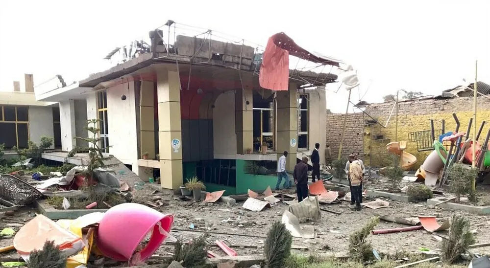 War-damaged buildings beside a playground in Mekelle, Tigray, after earlier fighting. Photo: public domain via Wikimedia Commons.