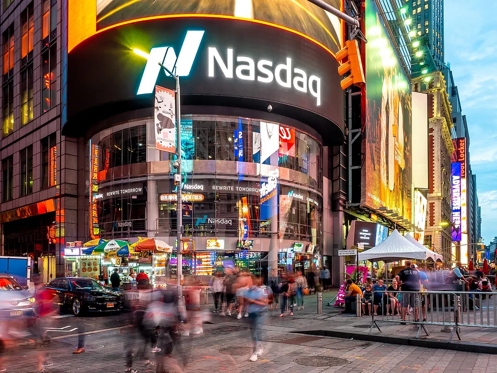 The Nasdaq MarketSite tower and curved ticker screens in Times Square at dusk. Photo: Ajay Suresh / Wikimedia Commons, CC BY 2.0.