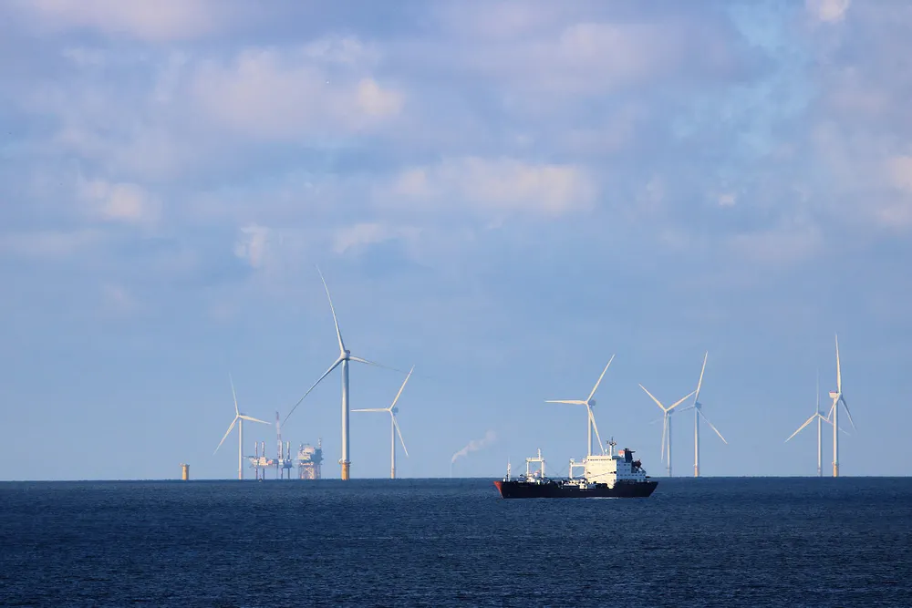 An oil tanker in the North Sea, with wind turbines and a platform on the horizon. Photo: ImagePerson / Wikimedia Commons, CC BY 4.0.
